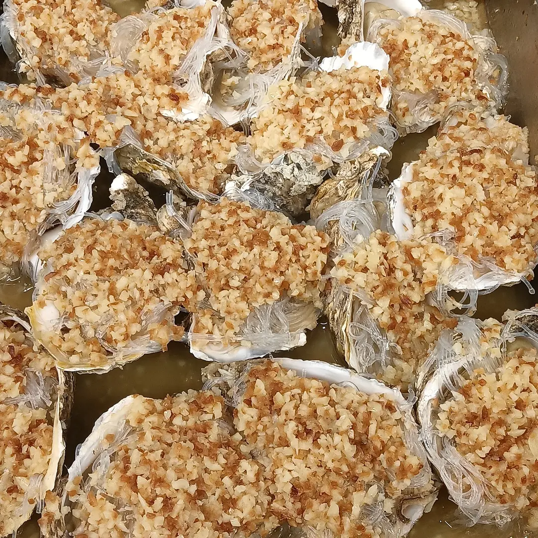 Oysters in the half shell steamed under garlic and glass noodles
