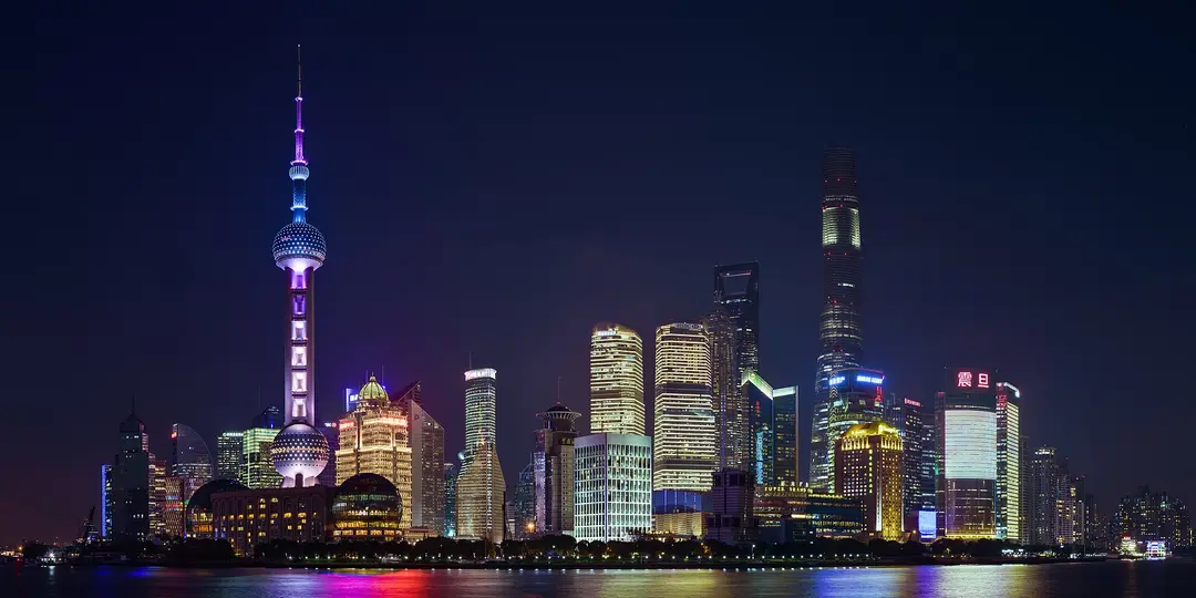 The towers of Lujiazui in Shanghai lit up at night across the Huangpu River