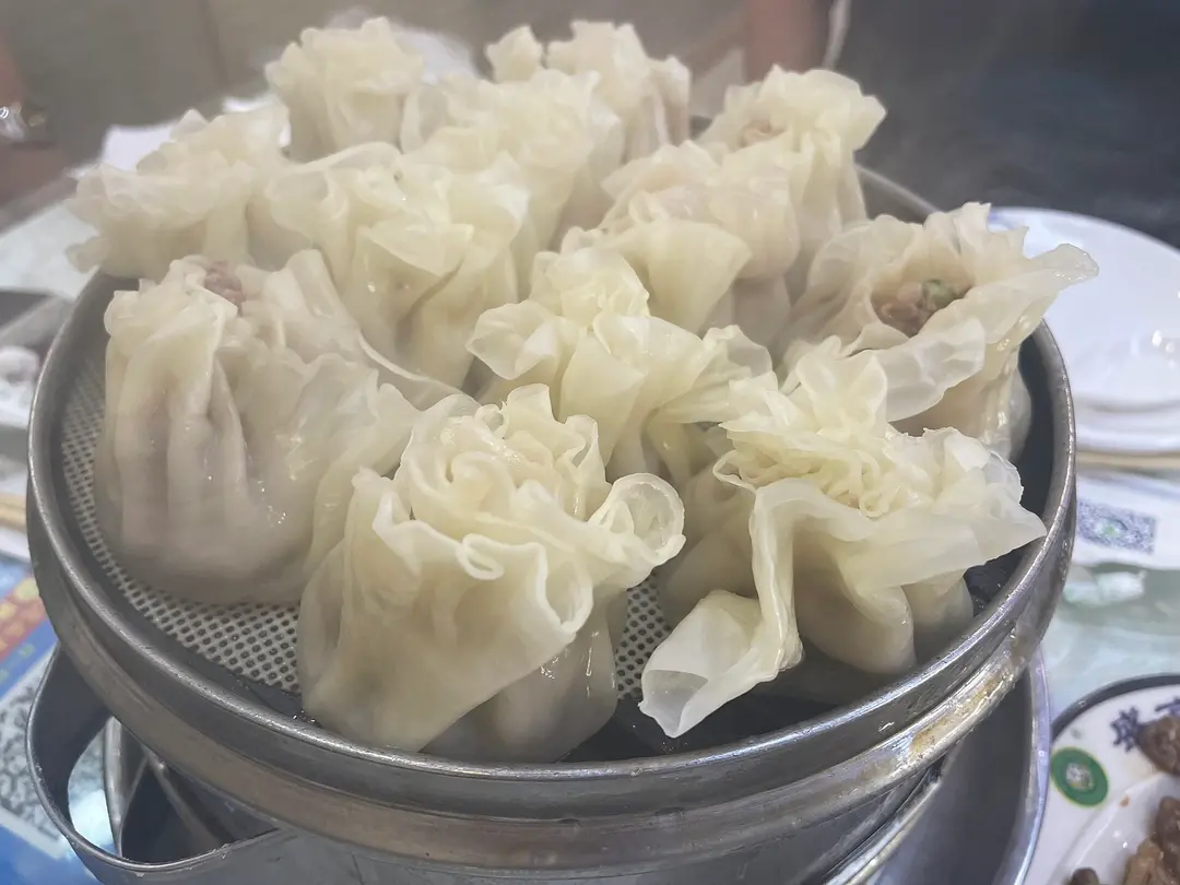 Steamer of thin-skinned dumplings with frilled tops