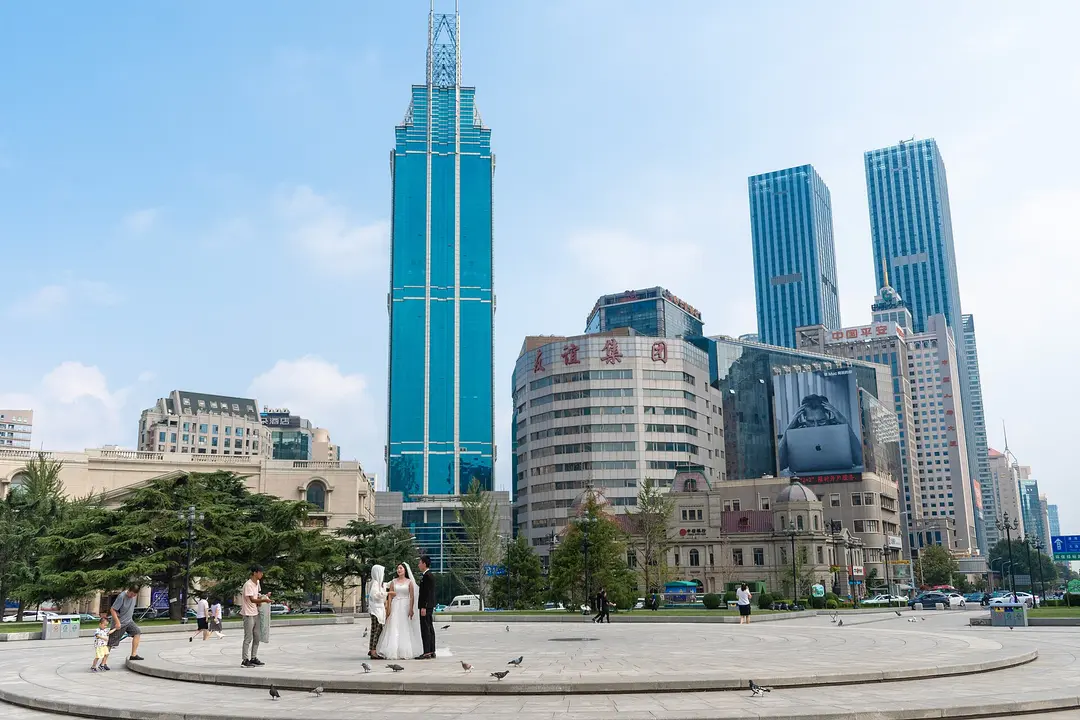 Zhongshan Square in summer, with domed early 20th-century bank buildings in front of glass towers