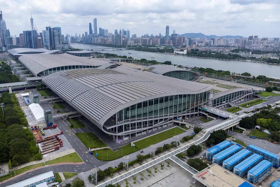 Aerial view of the Canton Fair Complex halls in Guangzhou, with the Pearl River and city towers behind