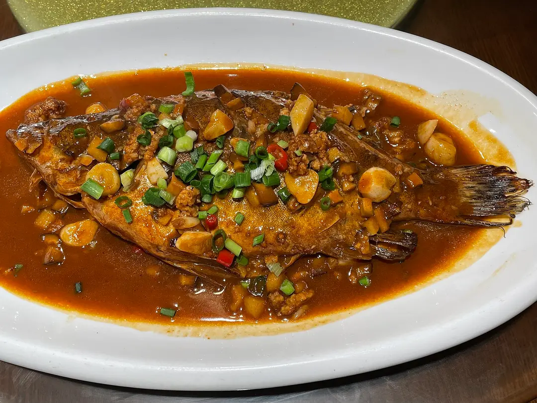 Stinky mandarin fish braised in a brown sauce with garlic and chili