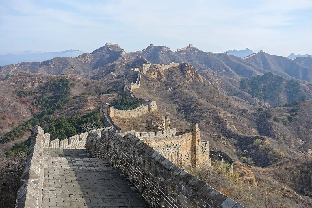 Ming brick Great Wall at Jinshanling climbing over dry autumn hills past a line of watchtowers