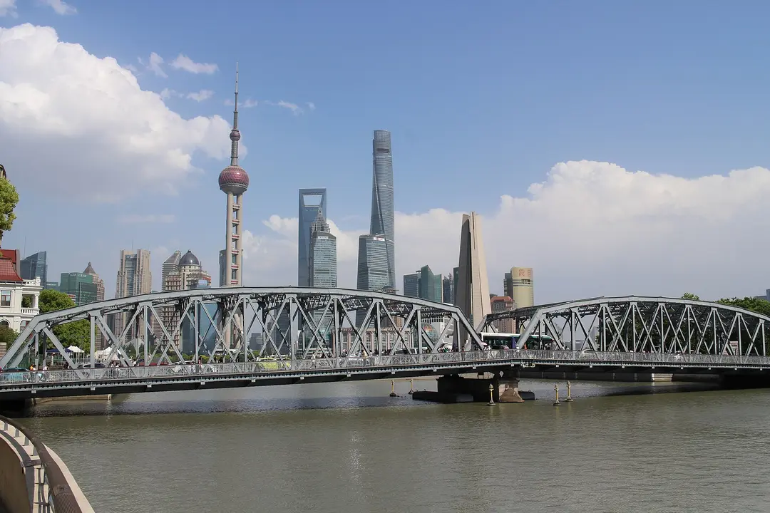 The steel trusses of Waibaidu Bridge over Suzhou Creek, with the Pudong towers behind