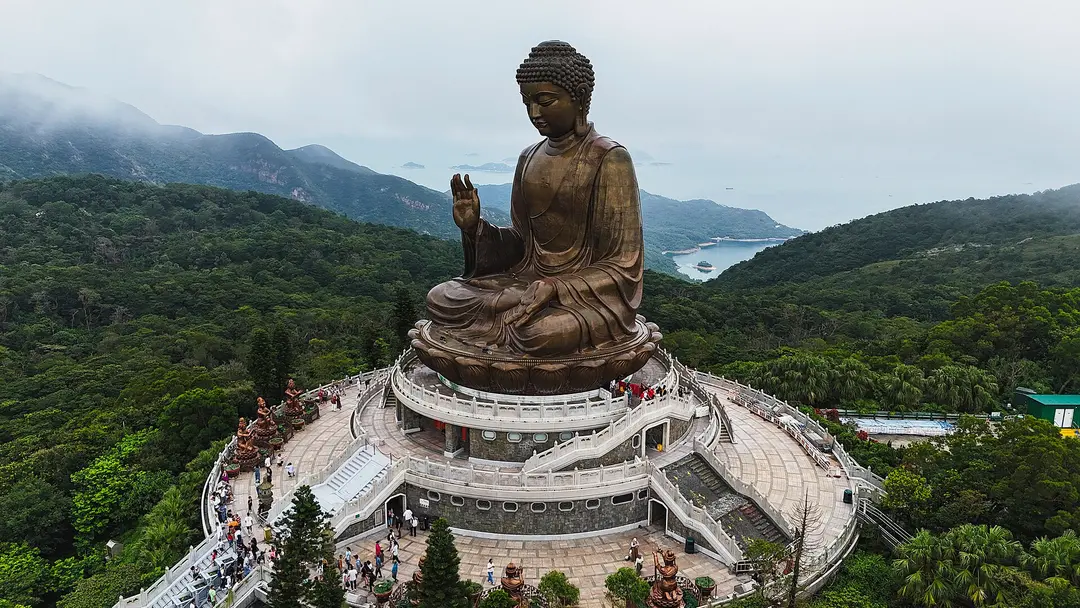 The bronze Tian Tan Buddha on its terraced platform above the green hills of Lantau Island