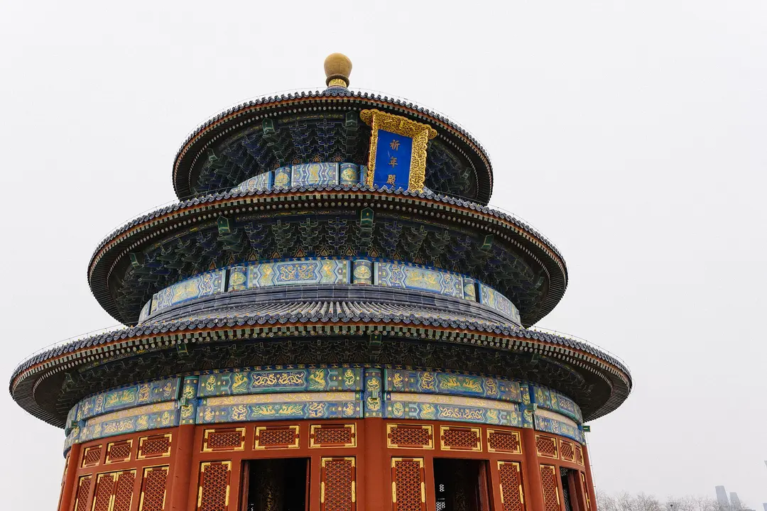 Close view of the blue-tiled roofs and painted eaves of the Hall of Prayer for Good Harvests